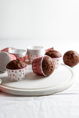 Homemade chocolate muffins (brownies) on white wooden background. Christmas food. Selective focus