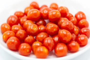 Fresh Tomato in a ceramic cup isolated white background 