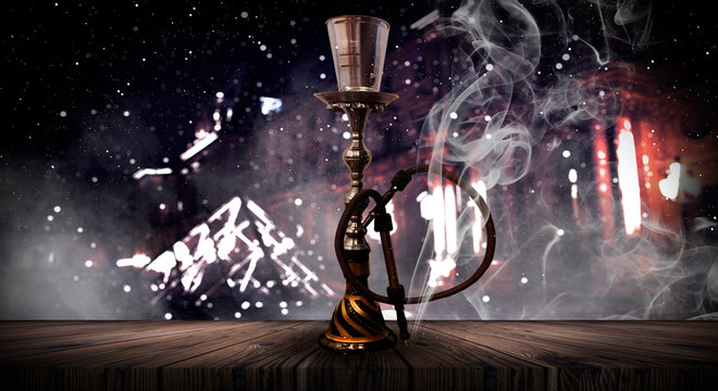 Hookah on the background of the night city, neon lights, with smoke.