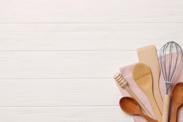 Kitchen utensils top view on wooden table. The devices helping for cooking. place to insert text