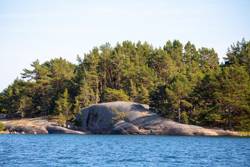 A sprawling toe-like smooth rocky boulder formation on the shore of an island in the Åland Islands, Finland, not far from the Island of Nicklösa.