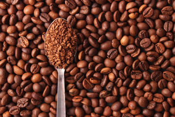 instant coffee in a spoon and coffee beans. Coffee, coffee drinks.
