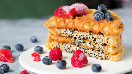 Waffles With Strawberry and Blue Berry in white plate.
