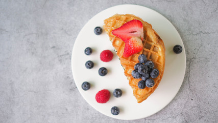 Waffles With Strawberry and Blue Berry in white plate.
