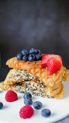 Waffles With Strawberry and Blue Berry in white plate.