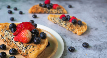 Waffles With Strawberry and Blue Berry in white plate.
