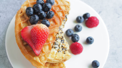 Waffles With Strawberry and Blue Berry in white plate.