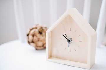 alarm clock on white wooden background. minimal concept