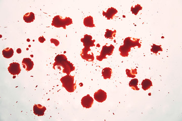 Blood-stained white surface. Disgusting view to the blood drops on whiteness. Bloody spits on...