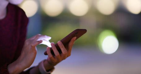 Woman use smart phone online at night © leungchopan