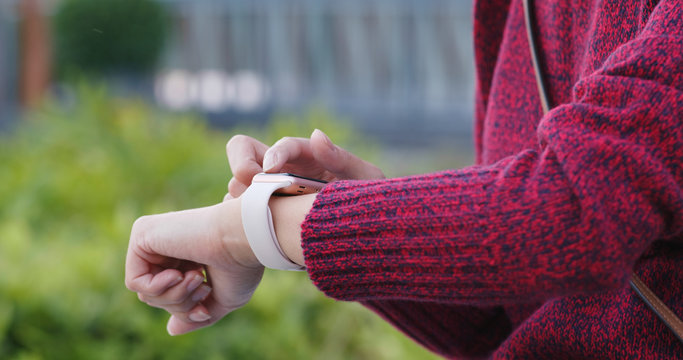 Woman use of smart watch in the park