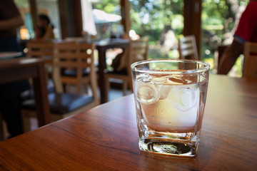 glass of water on wood table in restaurant