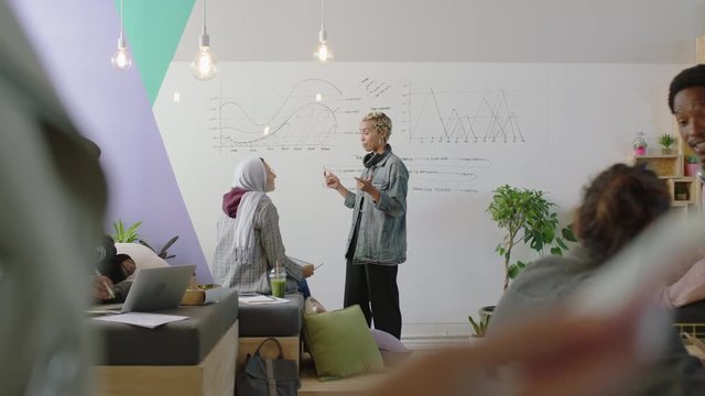 young multi ethnic business people celebrating successful project in modern startup office happy diverse students enjoying victory celebration clapping arms raised