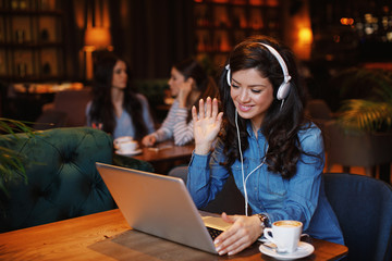 Woman have business meeting via video call in a cafe