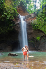 couple looking at the gorgeous waterfall in Bali