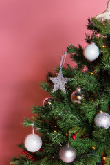 Christmas tree with beautiful ornaments on pink background