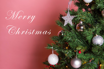 Christmas tree with beautiful ornaments on pink background