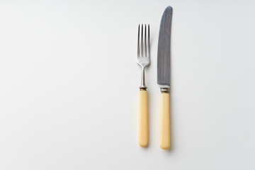 Vintage knife and fork on white background