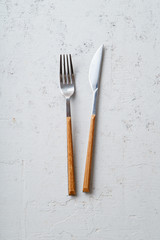 Knife and fork on concrete stone background