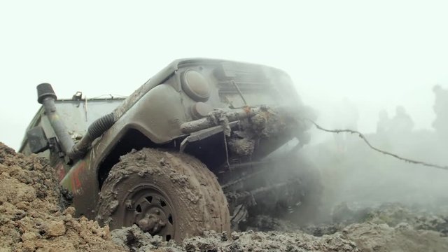 Сar goes through the mud