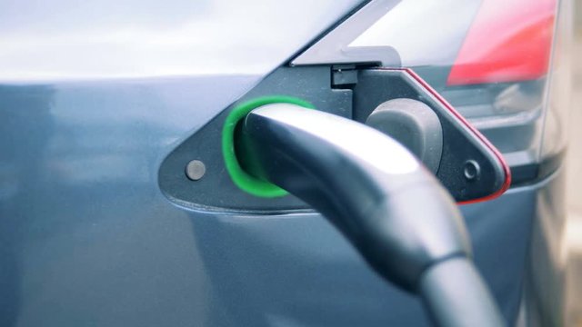 Filler socket of an electrocar with a discharge nozzle inserted into it
