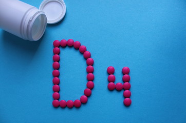 the letter D 4 is lined with pills