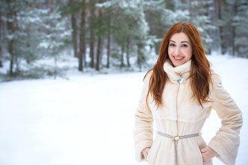 Pretty nice woman at christmas time outdoor , Fashionable lady in fur coat, magic seasone with good mood and luxury clothes