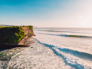 Aerial view of big waves at sunset. Biggest stormy waves in Bali and coastline