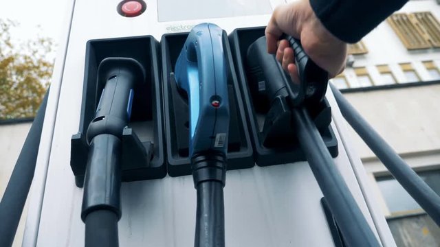 Filling panel with reloading nozzles for electrocars inserted into it