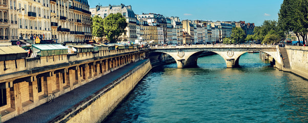 Narrow channel near Notre Dame with bridge Pont Saint-Michel over river Seine in Paris, France