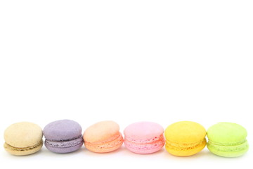 Line of colorful fresh sweet cake macaroons on the white background, have copy space for put text. pastel color.