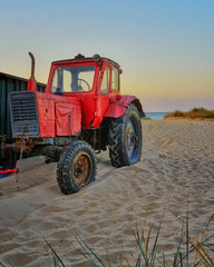 Beach with red tractor at the Baltic Sea. Ahlbeck, Germany