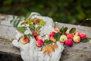 apples on a wooden background in the autumn street, lights