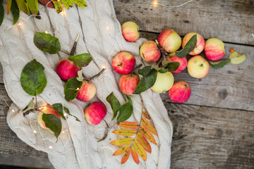 apples on a wooden background in the autumn street, lights