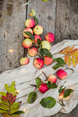 apples on a wooden background in the autumn street, lights