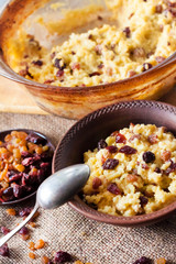 Sweet millet porridge with raisins and dried cranberries