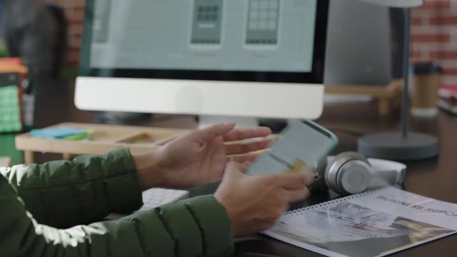 close up hands engineer woman using computer developing software app working on design project checking smartphone browsing online research brainstorming solution for startup company