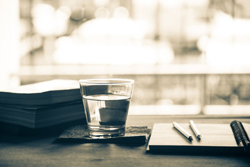 Space of reader and writer with drink water, notepad and pencil for memory thinking on desk office