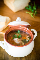 vegetable soup with beans and meatballs in a ceramic bowl