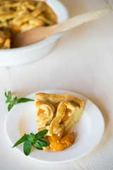 homemade pie with apricots on wooden rustic background
