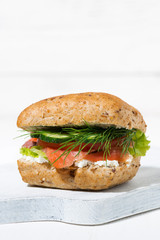 sandwich with salted fish and cream cheese on white wooden board, vertical