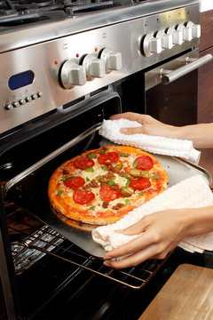 REMOVING PIZZA FROM OVEN