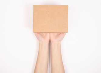 Fototapeta premium Box in hand. Isolation top view on white background.