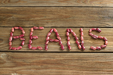 Dried red kidney beans on wooden background