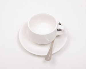 Obraz na płótnie Canvas White saucer cup spoon on white background isolation, top view