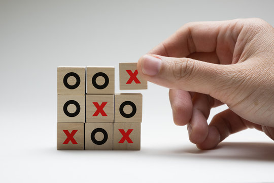 Business or marketing strategy planning concept using wooden cubes tic tac toe board game