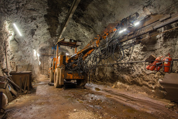 Fototapeta na wymiar Underground gold iron copper ore mine shaft tunnel gallery passage with drilling machine