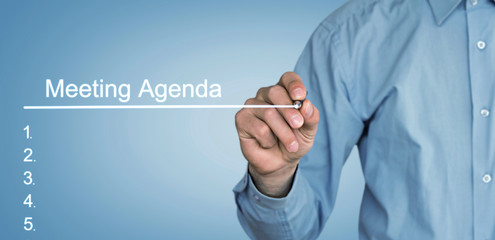 Fototapeta premium Businessman writing Meeting Agenda in screen.