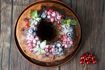 Chocolate cake with chocolate icing, mint  and fresh berries.