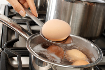 WOMAN BOILING EGGS
